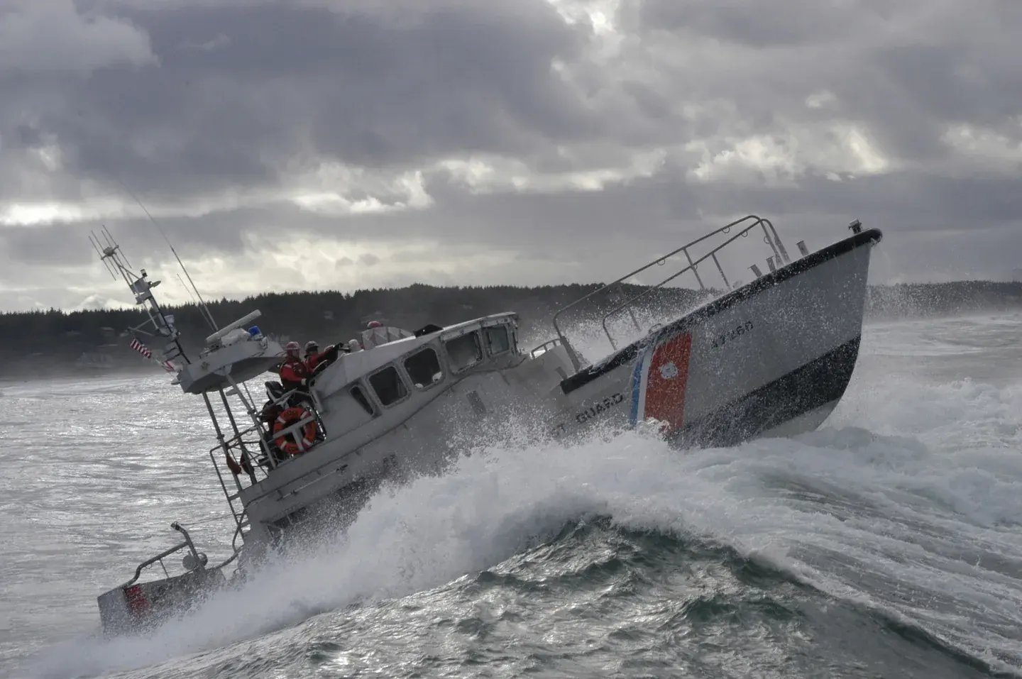 U.S. Coast Guard motor lifeboat breaks through a wave during a rescue exercise